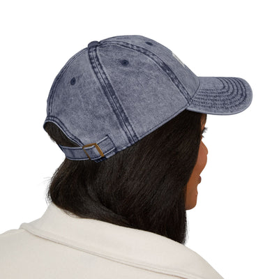 Person wearing a denim cap on a white background