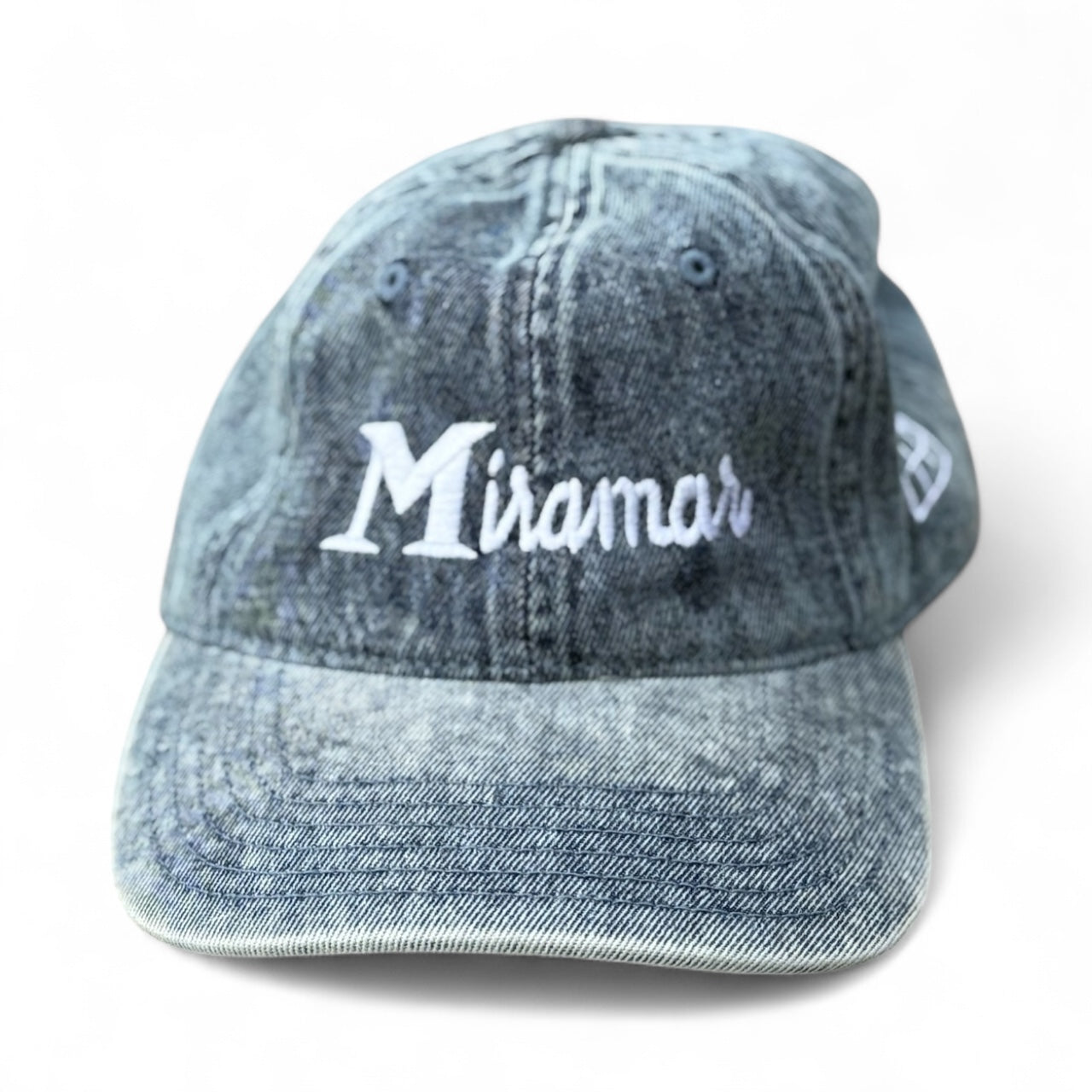 Blue denim cap with 'Miramar' embroidery on a white background