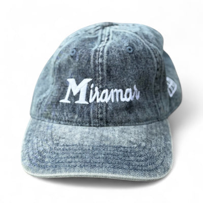 Blue denim cap with 'Miramar' embroidery on a white background