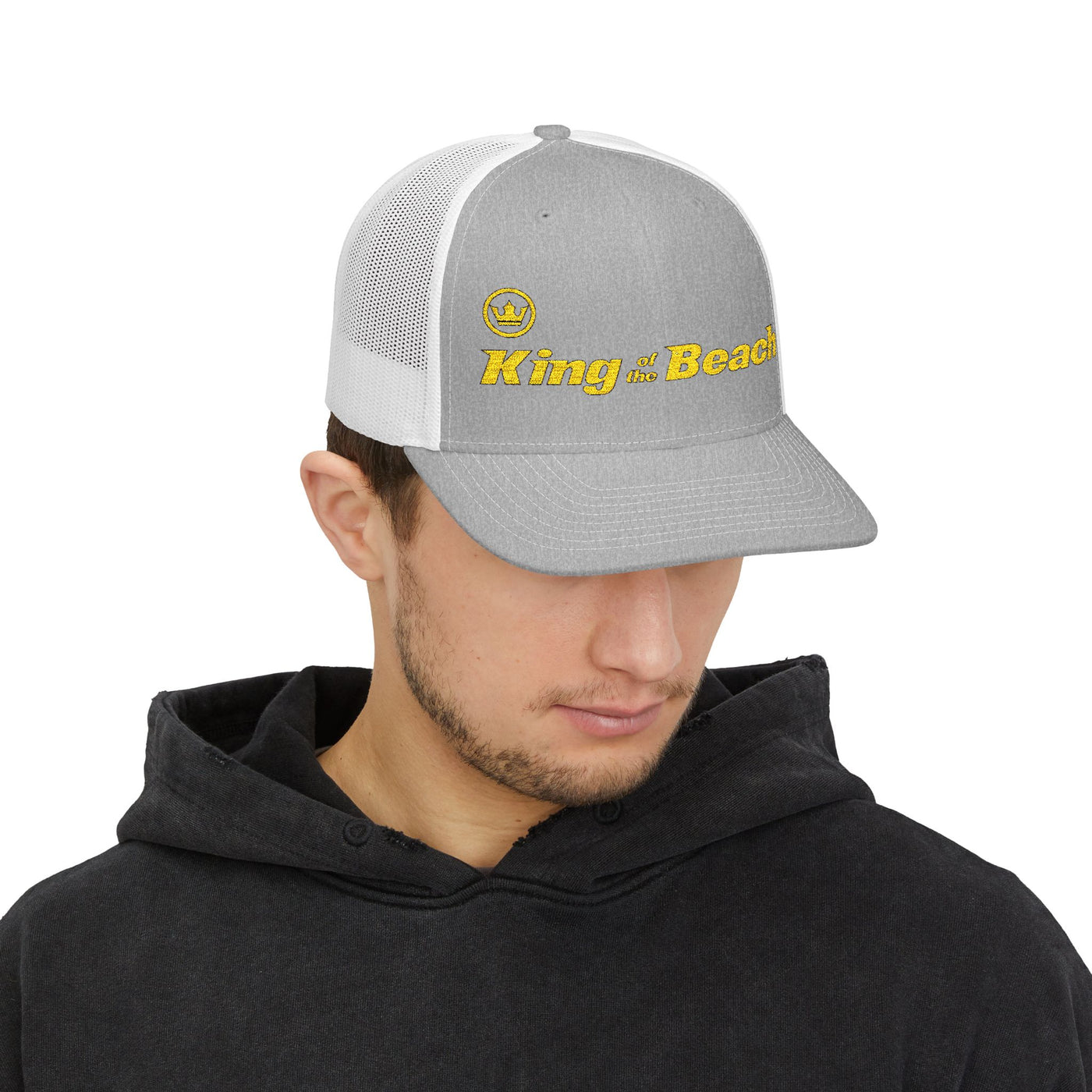 Man wearing a gray and white cap with 'King of the Beach' text on a white background