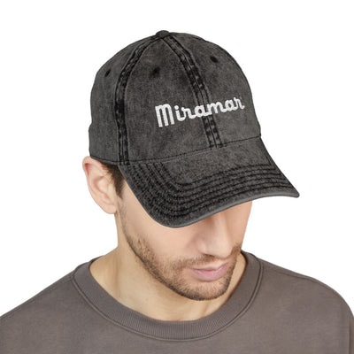 Man wearing a black denim cap with 'Miramar' 