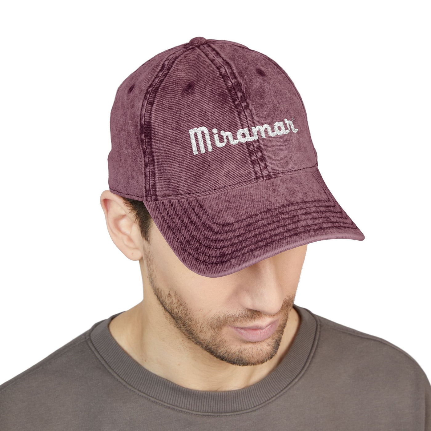Man wearing a maroon cap with 'Miramar' logo on a white background