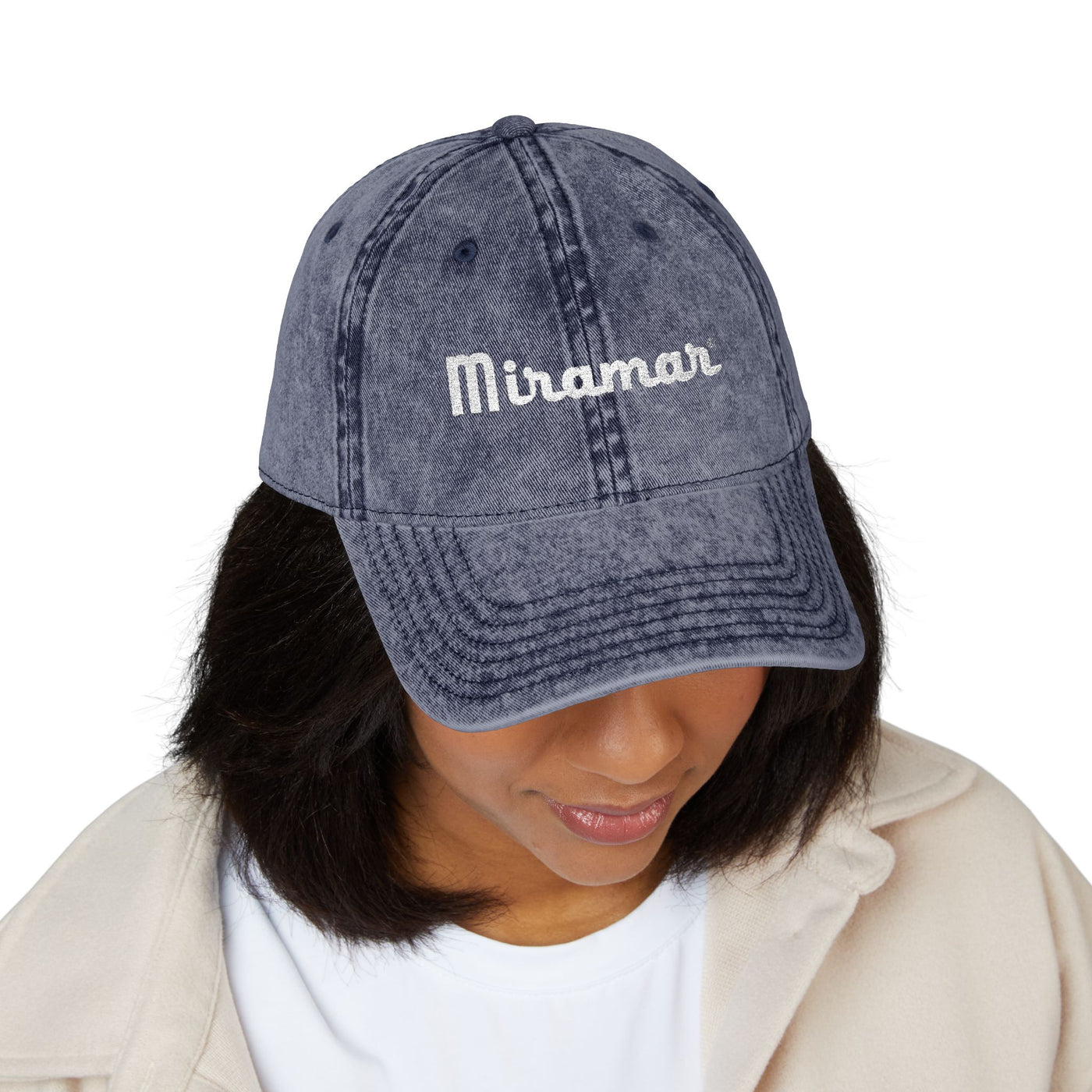 women wearing a denim cap with 'Miramar' embroidery on a white background