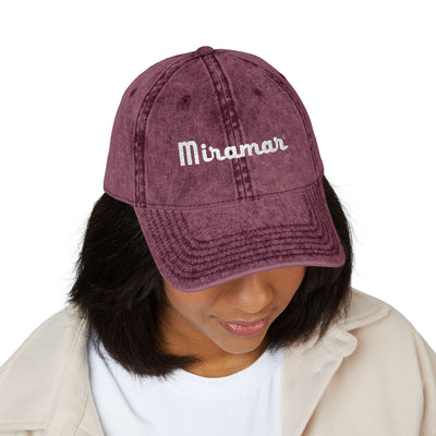 Women wearing a maroon cap with 'Miramar' text on a white background