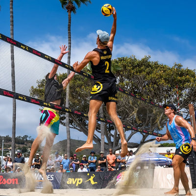 Beach volleyball player in action with a net and spectators in the background