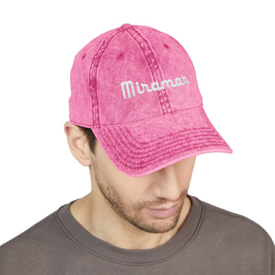 man wearing a pink cap with 'Miramar' logo on a white background
