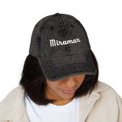 women wearing a black cap with 'Miramar' 